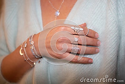 Cropped view of woman golden necklaces rings jewellery Stock Photo