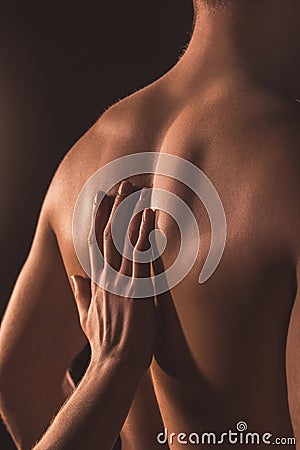 cropped view of woman touching back of her lover, Stock Photo