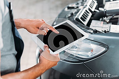 cropped view of workman using digital tablet in auto Stock Photo