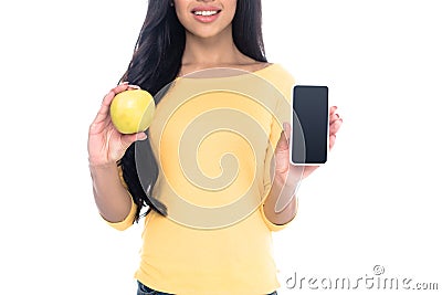 cropped white of smiling african american girl holding apple and smartphone with blank screen isolated Stock Photo