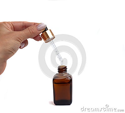 Cropped white woman& x27;s hands holding cosmetic dropper on isolated white background Stock Photo