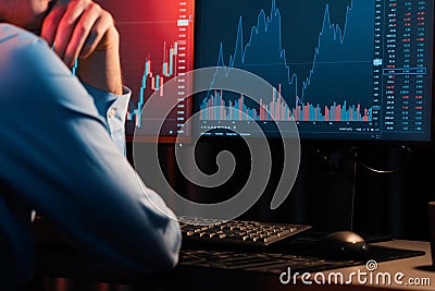 Cropped trader analyzing on market stock graph with back sideways view. Gusher. Stock Photo
