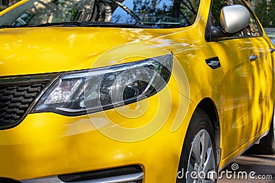 Cropped yellow shining car in the street Stock Photo