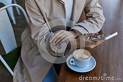 cropped young woman in trench coat Stock Photo
