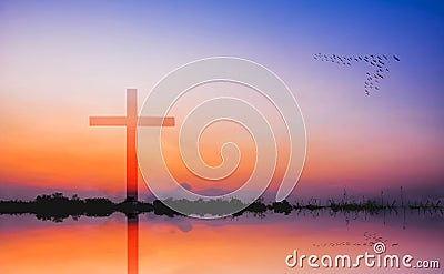 Cross against mountain and lake view at sunset Stock Photo