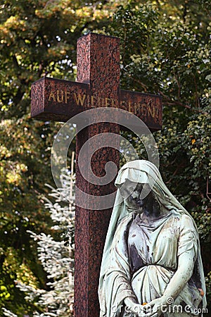 A cross and a angel in a cemetery Stock Photo