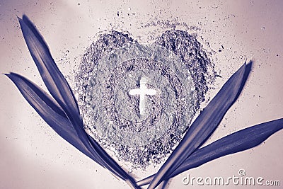 Cross or crucifix in heart shaped ash with palm leaves. Purple, monochromatic. Lent Season, Holy Week, Palm Sunday and Good Friday Stock Photo