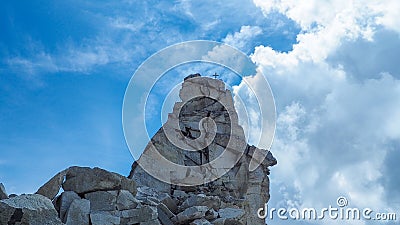 Cross high on a rock. Stock Photo