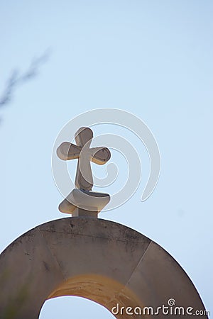 A cross high sen of a bell tower in CrÃ¨te - CrÃ¨te Stock Photo