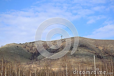 Cross and inscription on the mountain. Translation from Russian: bless and save. Karabash, zone of ecological disaster. Russia Stock Photo