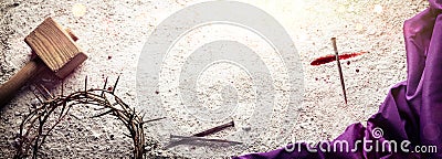 Cross Made With Blood And Nail On Arid Dirt Floor With Crown Of Thorns, Hammer And Purple Robe Stock Photo