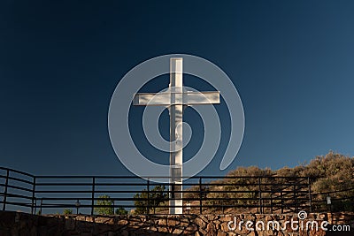 Cross of the Martyrs against a blue sky on the hilltop in Santa Fe, New Mexico Stock Photo