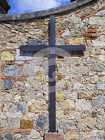 Cross in an old tuscan wall wall Stock Photo