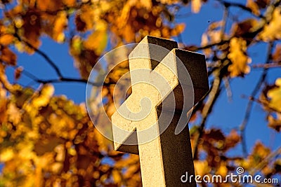Cross of a pilgrim way with autumnal painted leaves Stock Photo