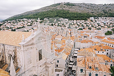 Cross on the red tiled roof of the Cathedral of St. Ignatius. Dubrovnik, Croatia. Drone Stock Photo