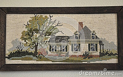 Cross stitched old house in frame Stock Photo