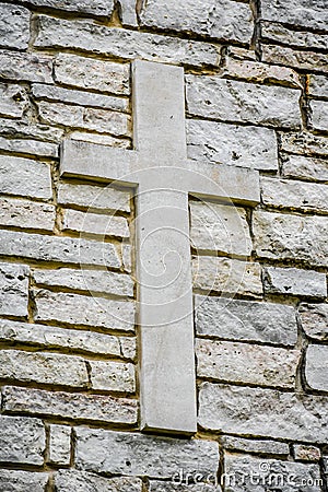 Cross on Stone Brick Wall Stock Photo