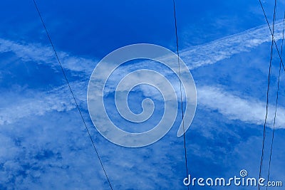 Cross trail of condensation in the sky Stock Photo