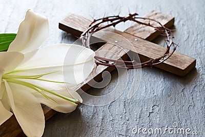 Cross and white lily on black marble background. Passion and resurrection of Christ concept Stock Photo