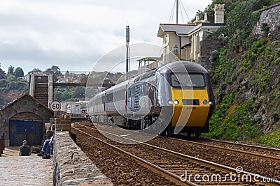 A CrossCountry train on the sea wall at Dawlish in Devon Editorial Stock Photo