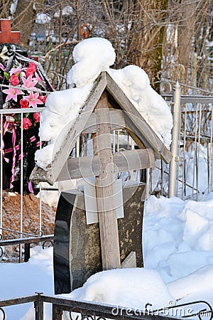 Crosses in a cemetery, monuments of the dead, a cemetery in winter, wreaths, artificial flowers. Russia Stock Photo