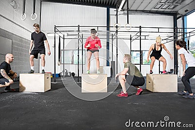 Crossfit group trains box jump Stock Photo