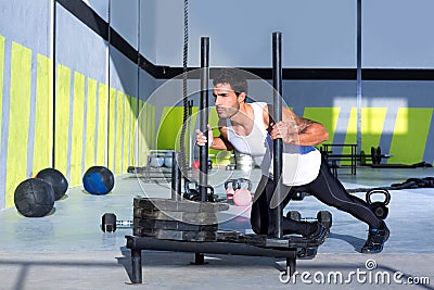 Crossfit sled push man pushing weights workout Stock Photo