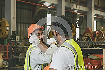 Crossing arms to greet good friendship, unity, smiles between two African American industrial workers. Stock Photo