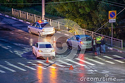 At the crossroads at night, the driver violated and knock down a pedestrian. The police draw up a road traffic accident. Police Stock Photo