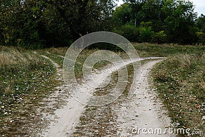 Crossroads, two different directions in the field at summertime. Stock Photo