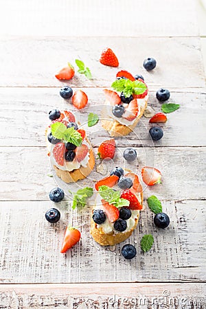 Crostini with grilled baguette, cream cheese and berries Stock Photo