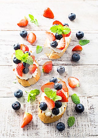 Crostini with grilled baguette, cream cheese and berries Stock Photo