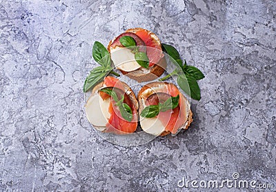 Crostini with salmon, mozarella, tomato and basil Stock Photo