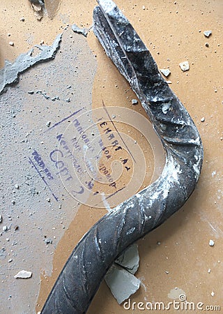 Crowbar on the old drywall. Stamp with an inscription in Russian â€œLeningrad plant of plaster and marble products. . Gr Editorial Stock Photo