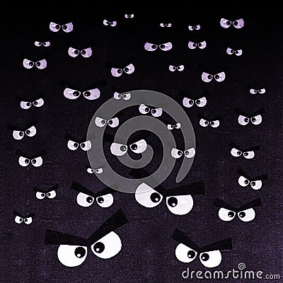 The crowd of angry eyes on a dark background Stock Photo