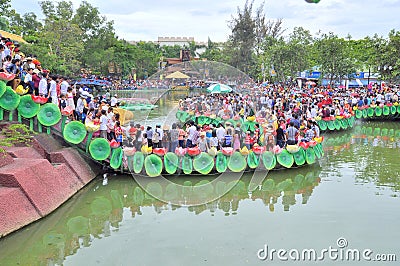 Crowd of Buddhists are offering incense to Buddha with thousand hands and thousand eyes in the Suoi Tien park in Saigon Editorial Stock Photo