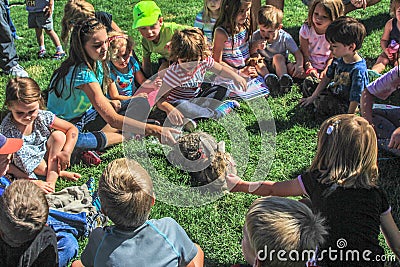 Crowd of Children petting a rabbit Editorial Stock Photo