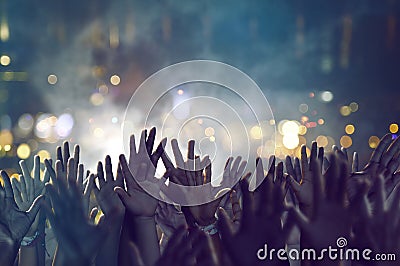 Crowd holds hands in the air Stock Photo