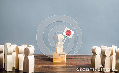 The crowd looks at a man with a poster showing discontent anger. Disagreement and denial. Drawing public attention to the problem Stock Photo