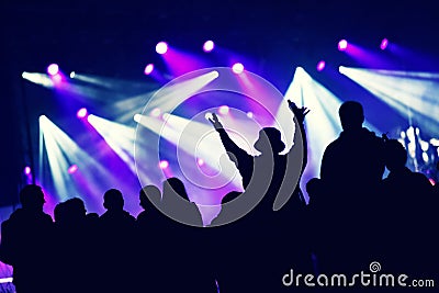 Crowd at a music concert, audience raising hands up Stock Photo