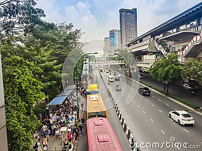 Crowd of passengers are queuing for bus at Phahon Yothin Road, interchange of Mochit BTS sky train station and Chatuchak MRT Editorial Stock Photo