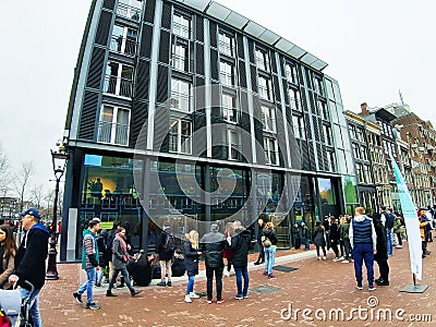 Crowd of people of acculturated tourists lining up to visit the Anna Frank house building and Amsterdam museum in winter Editorial Stock Photo