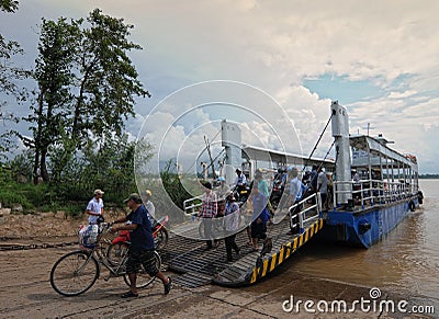 Crowd of people cross the river by ferry boat Editorial Stock Photo