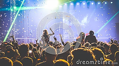 Crowd of people dancing at night club - Live concert festival event Editorial Stock Photo