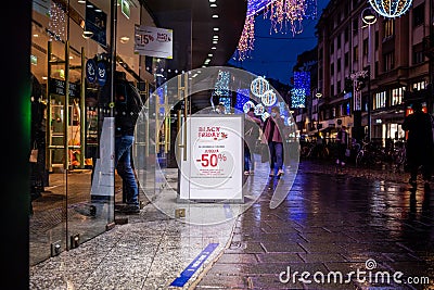Crowd of people entering the large luxury shopping mall at night with Editorial Stock Photo
