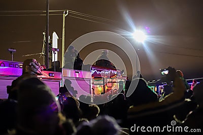 People and firefighters on a fire truck watch the arrival of the Canadian Pacific holiday train Editorial Stock Photo