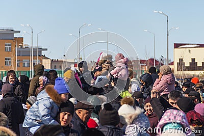 A crowd of people on a holiday watching a concert, children sit on the neck of their parents and watch a concert Editorial Stock Photo