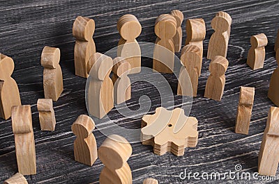 A crowd of people looks at the wooden gear of the mechanism. Process of production, manufactory. Plants and factories. Stock Photo