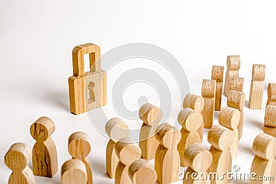 A crowd of people looks at a wooden padlock. The concept of security and safety. Protection of personal data and tangible property Stock Photo