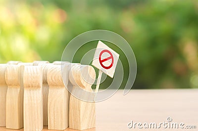 A crowd of people with posters protesting. An angry mob of wooden figures of people with a poster. Social discontent and social Stock Photo